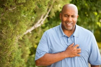 Man clutching chest in pain