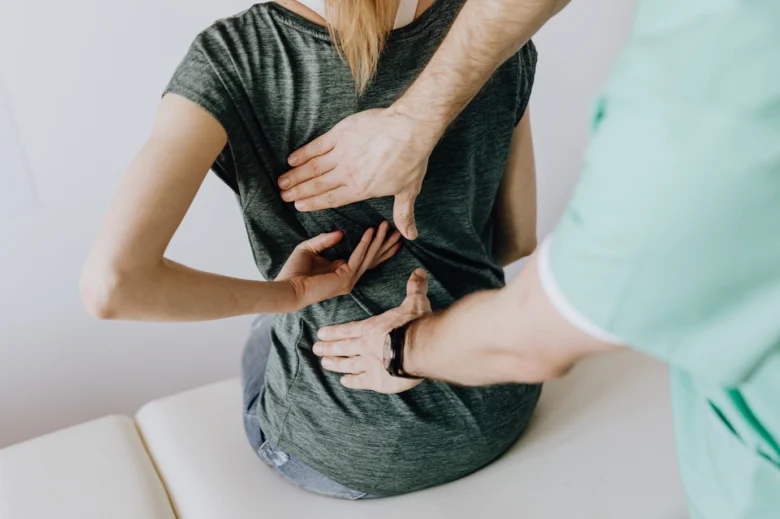 Physiotherapist examining back pain