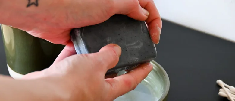 Charcoal soap bar being held