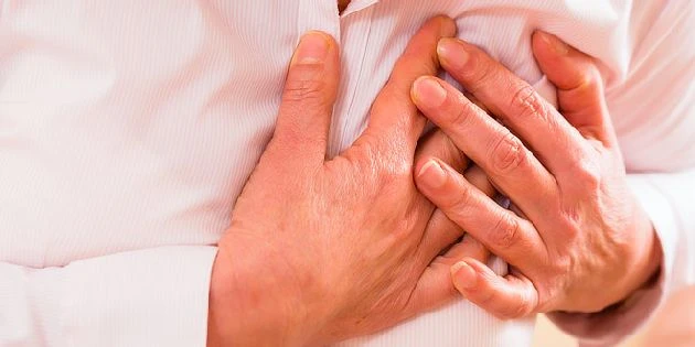 Hands clutching chest