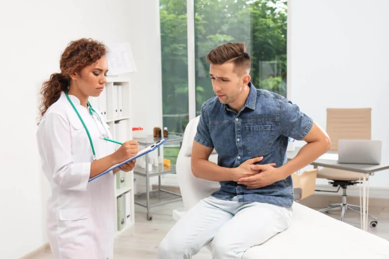 Man with stomach pain and doctor
