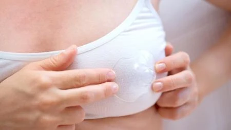 Žena drží absorpční podložku do košilky.
