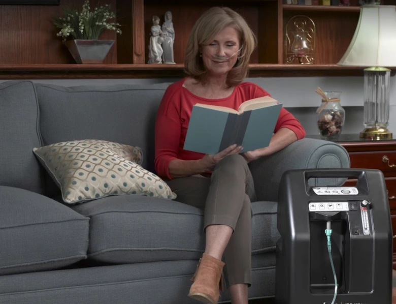 Woman reading with oxygen concentrator