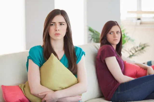 Two women arguing on couch