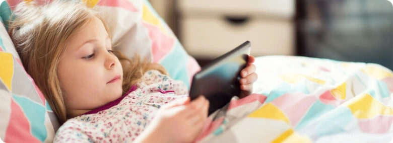 Girl resting in bed with tablet