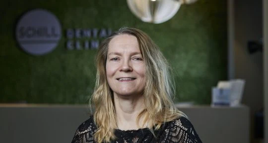 Woman smiling at reception desk