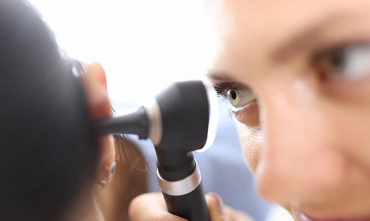 Ear examination with otoscope